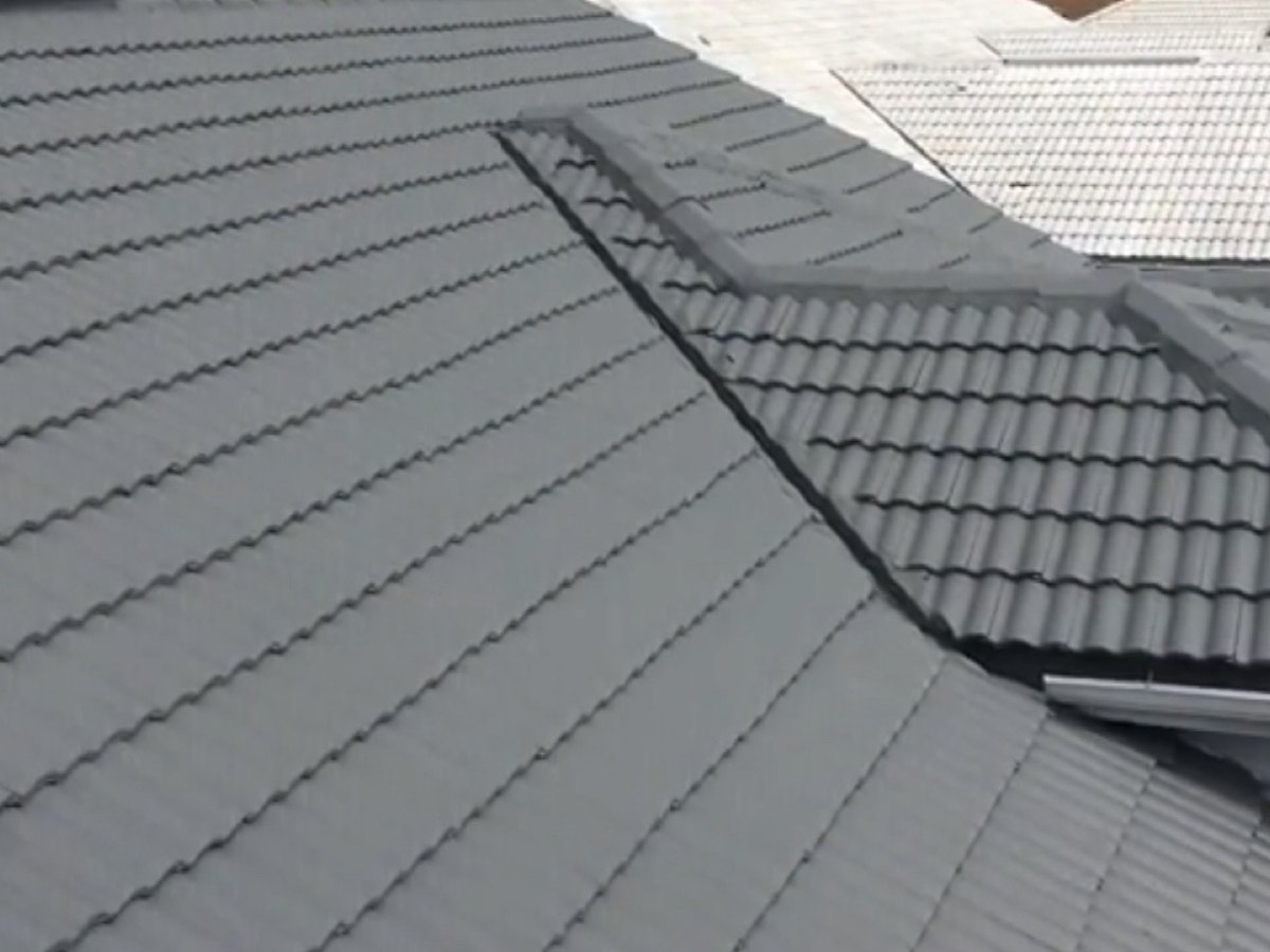 Charcoal grey metal roof after a protective coating was applied