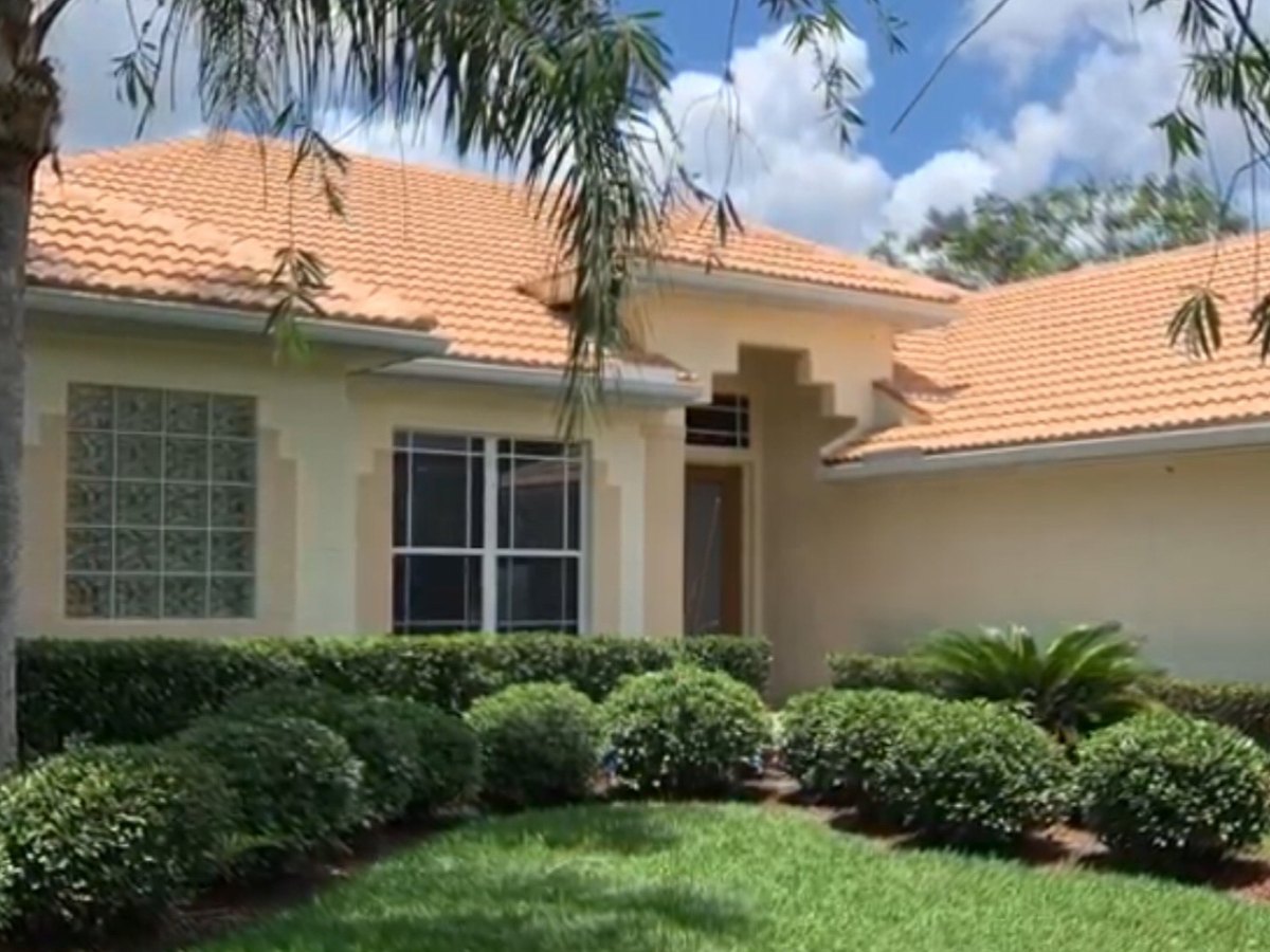 Florida home with a freshly coated roof and no torn-off roofing debris